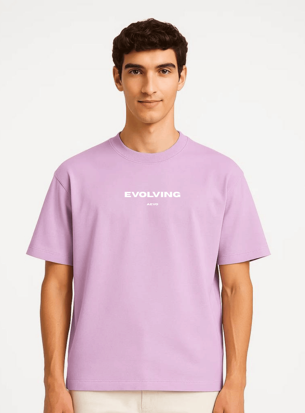 Person wearing a light purple t-shirt with 'Evolving' text on a white background